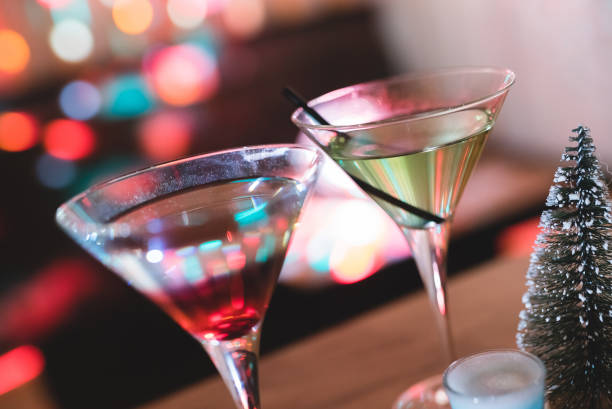 istock Cocktail glasses with Christmas lights in the back. 1008655956