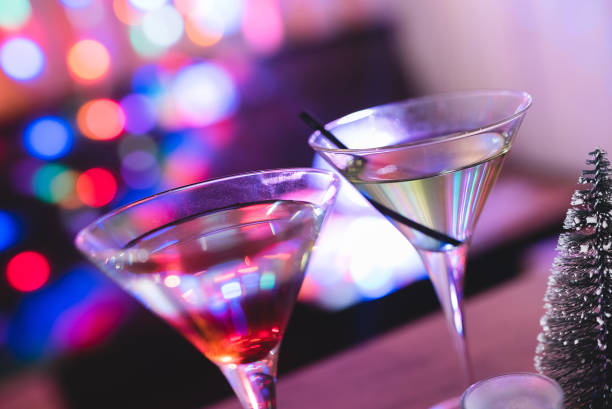 istock Cocktail glasses with Christmas lights in the back. 1008655964