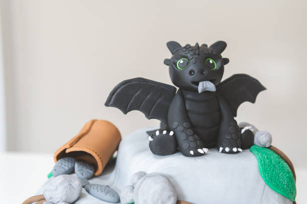 istock Black dragon eating fish on a rocky outcrop specialty cake 1008655970