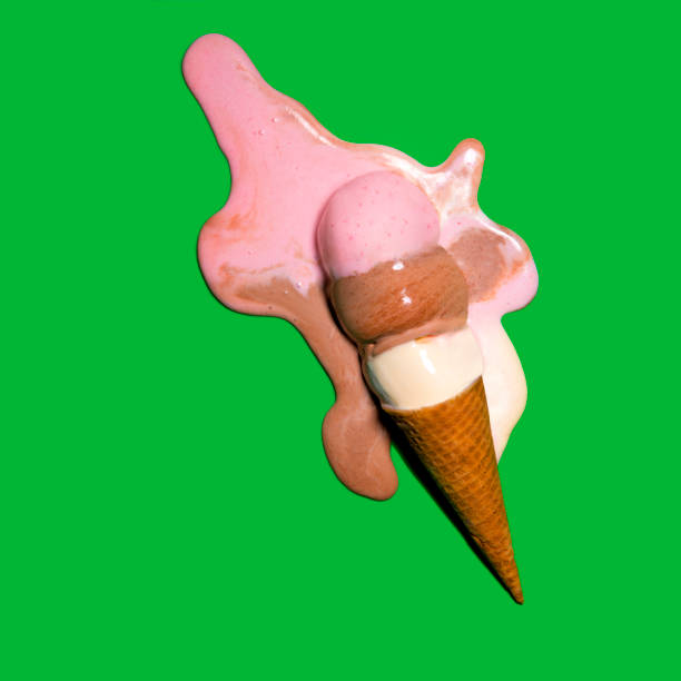 This is an overhead photograph of melted ice cream on a bright green background