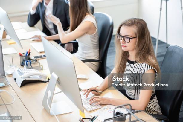 Businesswoman Working On Computer In The Office Stock Photo - Download Image Now - Junior Level, Office, Trainee