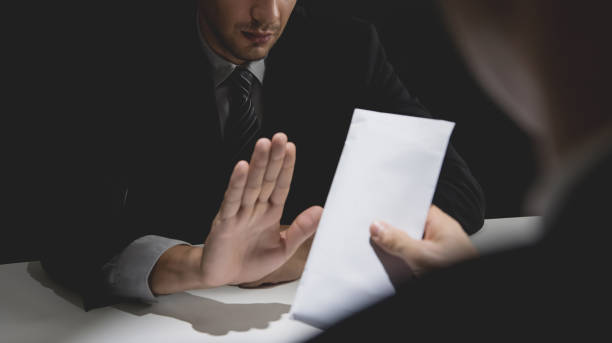 istock Businessman rejecting money in white envelope 1008681568