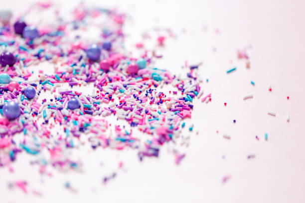 istock Colorful purple sprinkle blend on a pink background. 1008732220