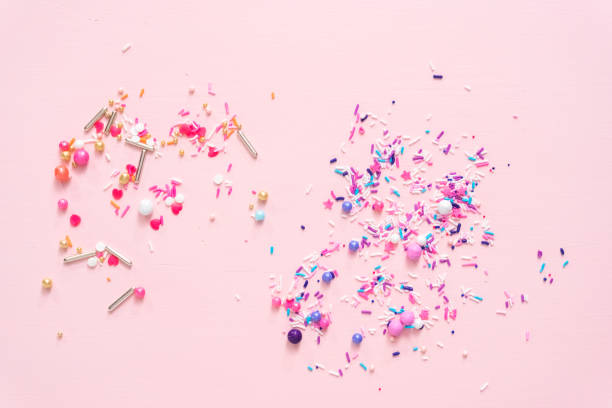 istock Colorful purple sprinkle blend on a pink background. 1008732262