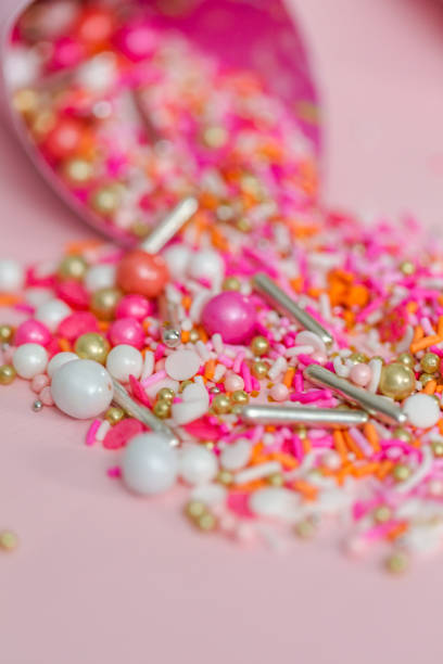 istock Colorful pink sprinkle blend on a pink background. 1008732282