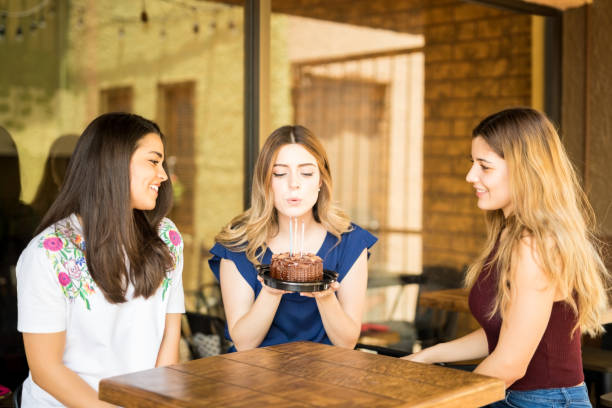 istock Blowing off birthday candles with friends 1008746246