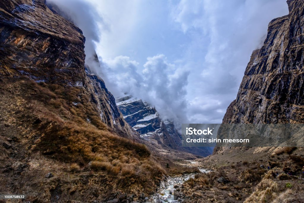 View of Mountains and stream from Machapurchhare base camp(MBC),Nepal,Himalayas. Stream among mountains and cloudscape,scenic nature. Beauty In Nature Stock Photo