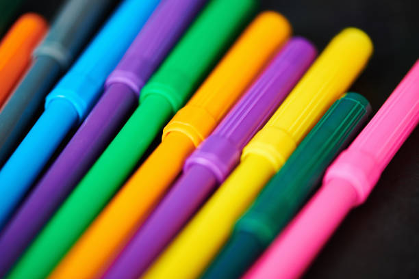 Colorful pens against weathered chalkboard