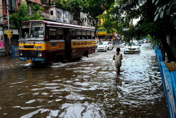 City Under Water Many parts of central and north Kolkata got waterlogged due to heavy downpour that started on wednesday night and continued all throughout the next day. Authorities are working overtime to clear the roads of stagnant water. monsoon stock pictures, royalty-free photos & images