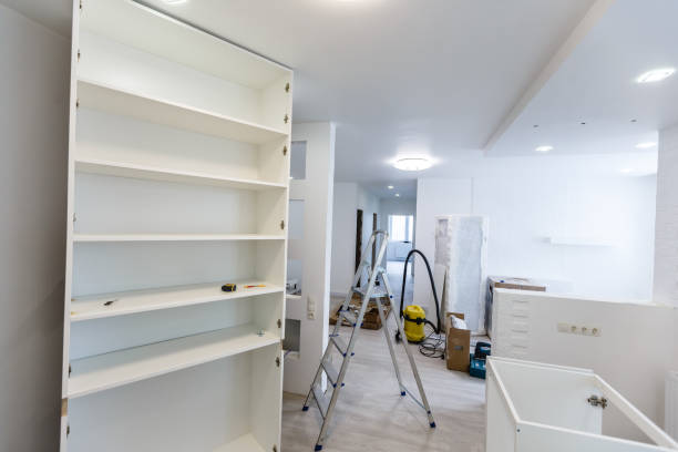 istock Custom kitchen cabinets in various stages of installation base for island in center 1008799400