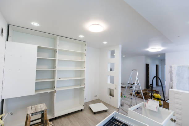 istock Custom kitchen cabinets in various stages of installation base for island in center 1008799456