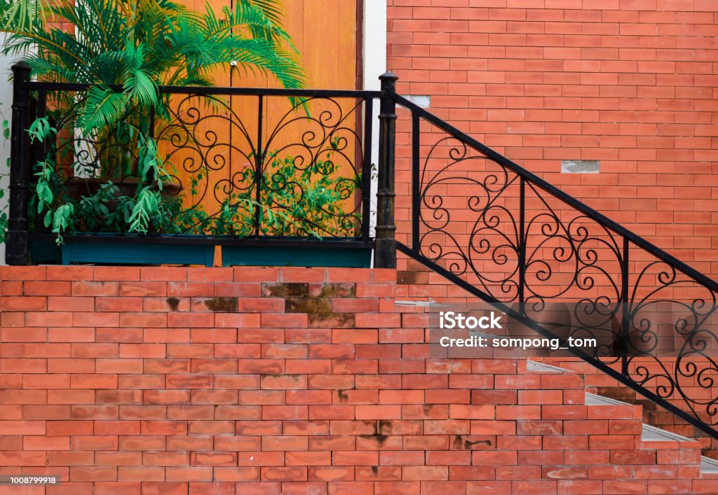 Old architecture staircase and tree the brick wall is brown. Iron - Metal Stock Photo