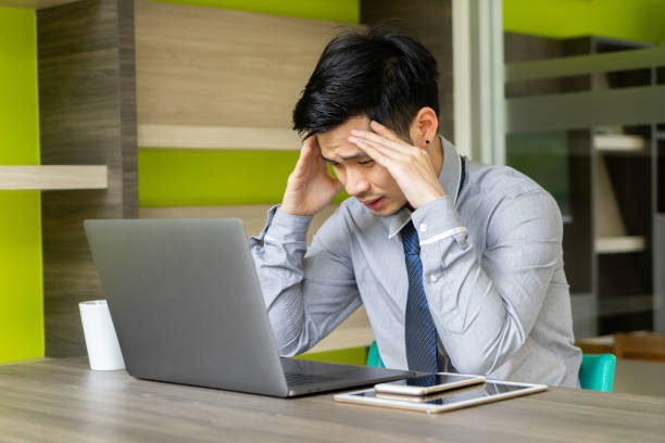 istock Business man feeling stressed with laptop computer. Young Asian male headache with project problem. people working with digital technology concept. 1008813382