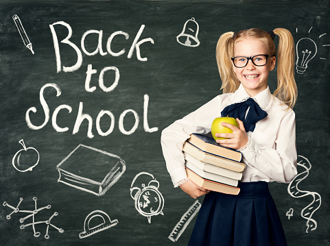 Child on Blackboard Background, Back to School Chalk Drawings on Black Chalkboard, Happy Girl in Glasses Holding Books and Apple