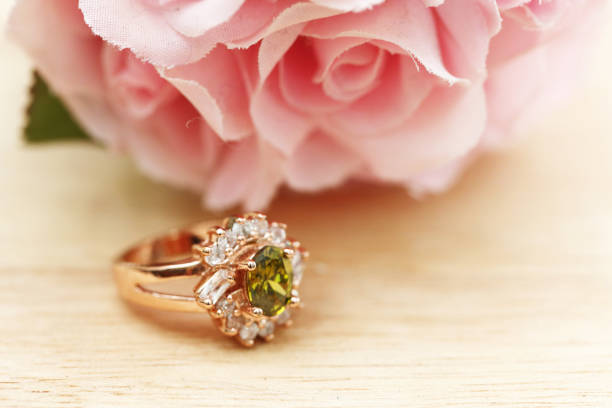 istock green gem stone and diamond on gold ring 1008825690