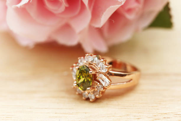 istock green gem stone and diamond on gold ring 1008825792