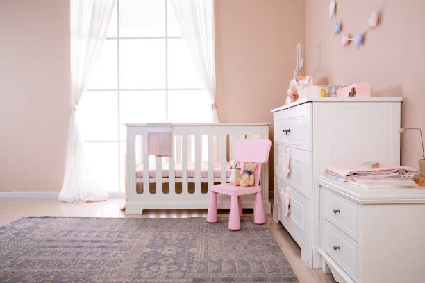 istock Simple, white baby bedroom with cot and rug 1008826244