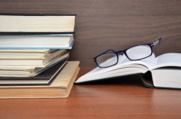 istock reading glasses with many books 1008831856