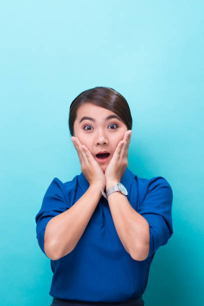 istock Surprised woman on isolated blue background 1008837324