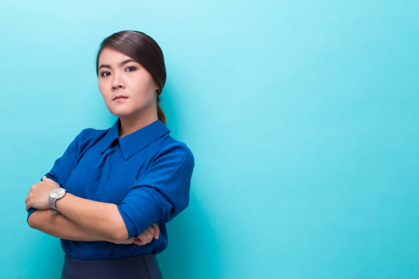istock Angry woman standing on isolated blue background 1008837694