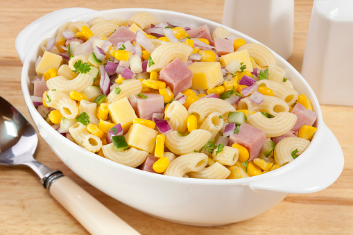Macaroni salad with ham, cheese, corn, red onion and cucumber.