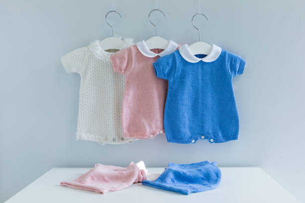 istock Children's clothes on laundry line against wooden background 1008845546