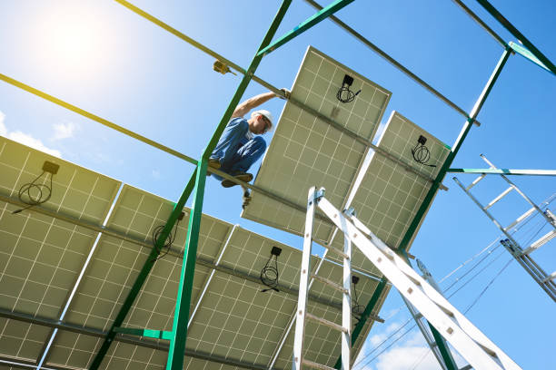 istock Professional worker installing solar panels on the green metal construction 1008854204