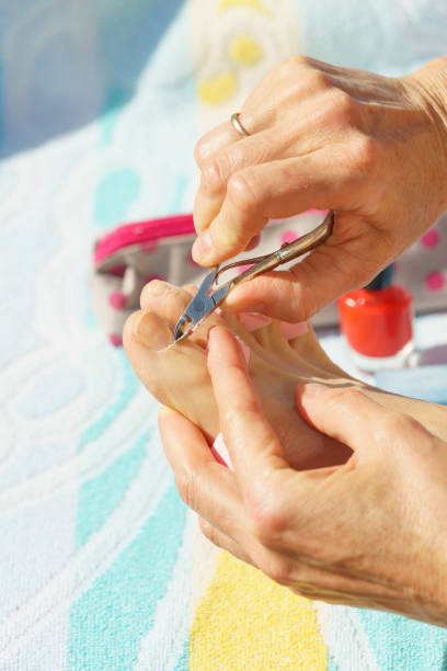 istock Woman trimming cuticles before pedicure 1008856480