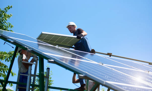 istock Professional worker installing solar panels on the green metal construction 1008856732