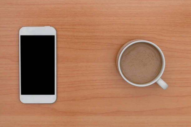istock coffee and smart phone on wooden table 1008857492