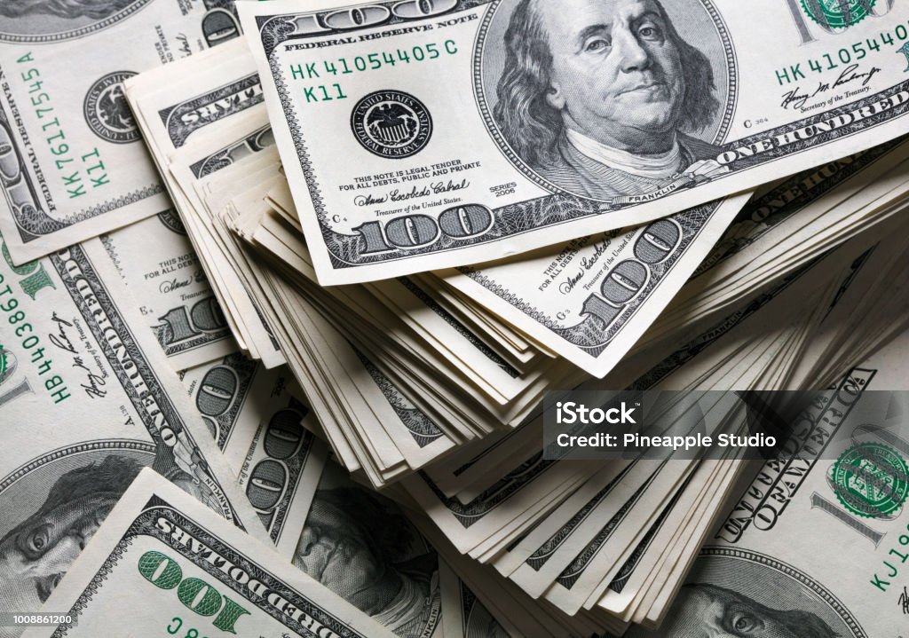 stack of one hundred dollars notes stack of one hundred dollars notes on dollars background Dollar Sign Stock Photo