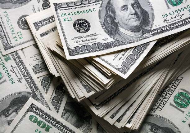 stack of one hundred dollars notes stack of one hundred dollars notes on dollars background dollar sign stock pictures, royalty-free photos & images