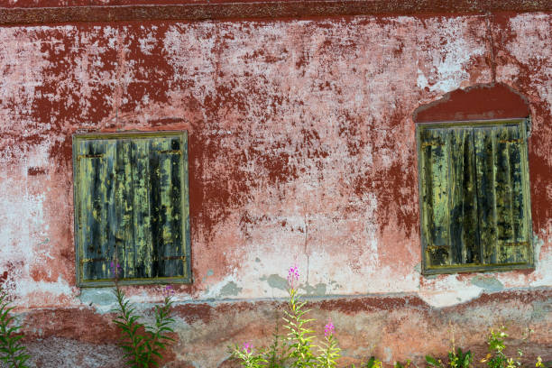 Old windows with weathered wood shutters in Dolomites, Italy, Europe. Nikon D850.