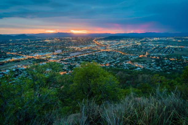 istock Illuminated city with sunset in the background at dusk 1008867406