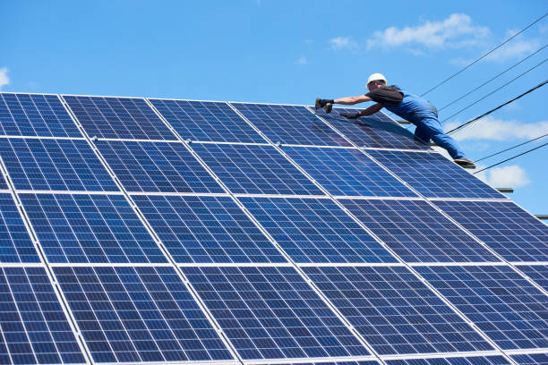istock Professional worker installing solar panels on the green metal construction 1008867858