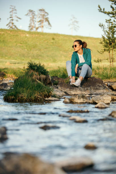 istock Young woman by the river 1008870228