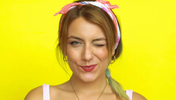 istock Young beautiful woman looks at the camera and winks 1008876252