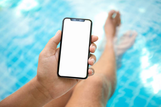 istock man at the pool holding phone with an isolated screen 1008876406