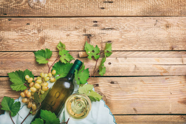 istock White wine glass and bottle and fresh grapes 1008876944