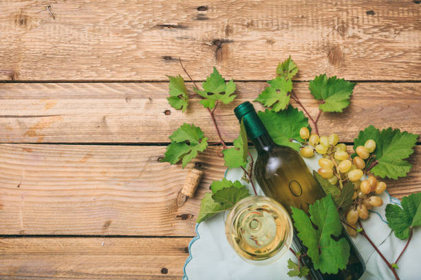 istock White wine glass and bottle and fresh grapes 1008876964