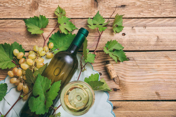 istock White wine glass and bottle and fresh grapes 1008876966