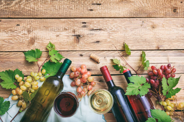 istock Red and white wine glasses, bottles, grapes 1008876978