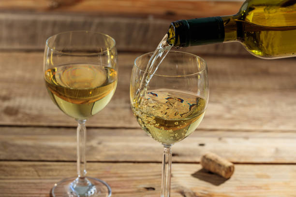 istock Pouring white wine in a glass 1008877006