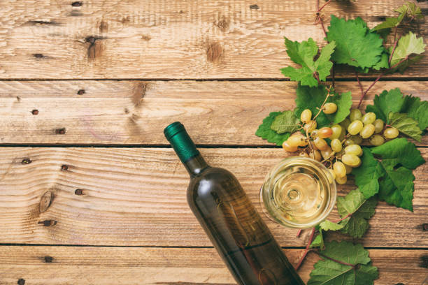 istock White wine glass, bottle and fresh grapes 1008879496