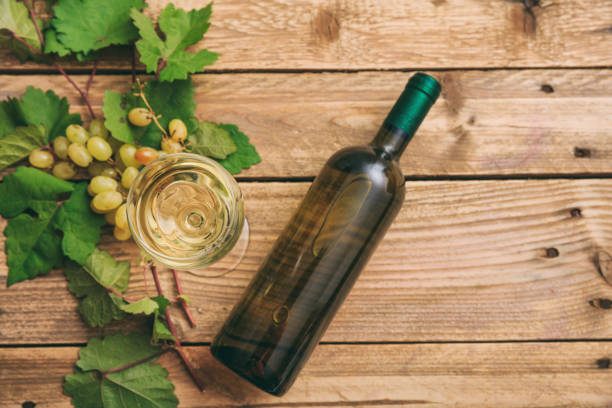 istock White wine glass, bottle and fresh grapes 1008879498