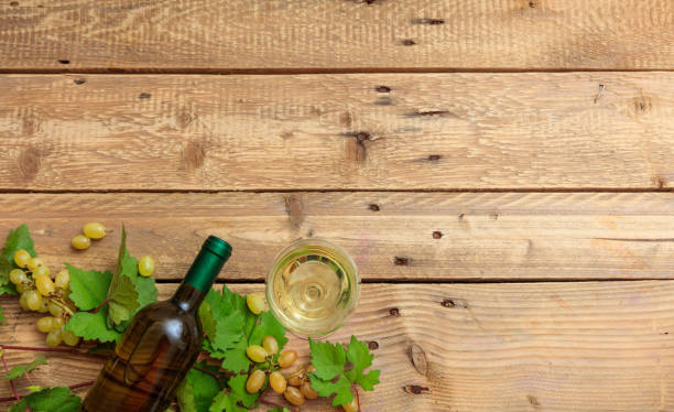 istock White wine glass and bottle and fresh grapes 1008879994