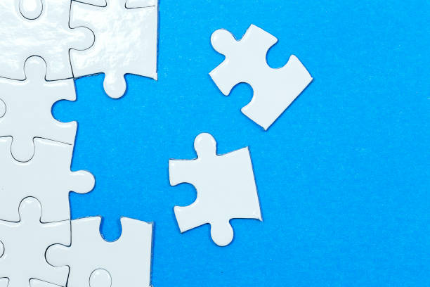 istock Blue background made from white puzzle pieces and place for your content 1008884726