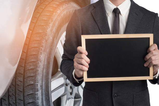 istock Mechanic hand checking and fixing a broken car in  garage.Inspector with tablet are checking list the car in car factory 1008885340