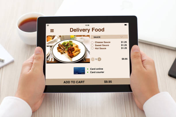 istock man hands holding tablet with app delivery food on screen 1008886776
