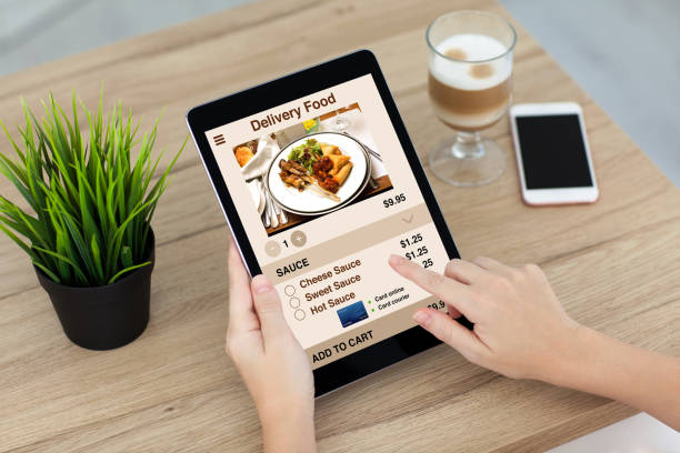 istock woman hands holding computer tablet with app delivery food screen 1008888336
